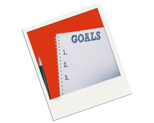 Goals workbook with pen on a polaroid picture.